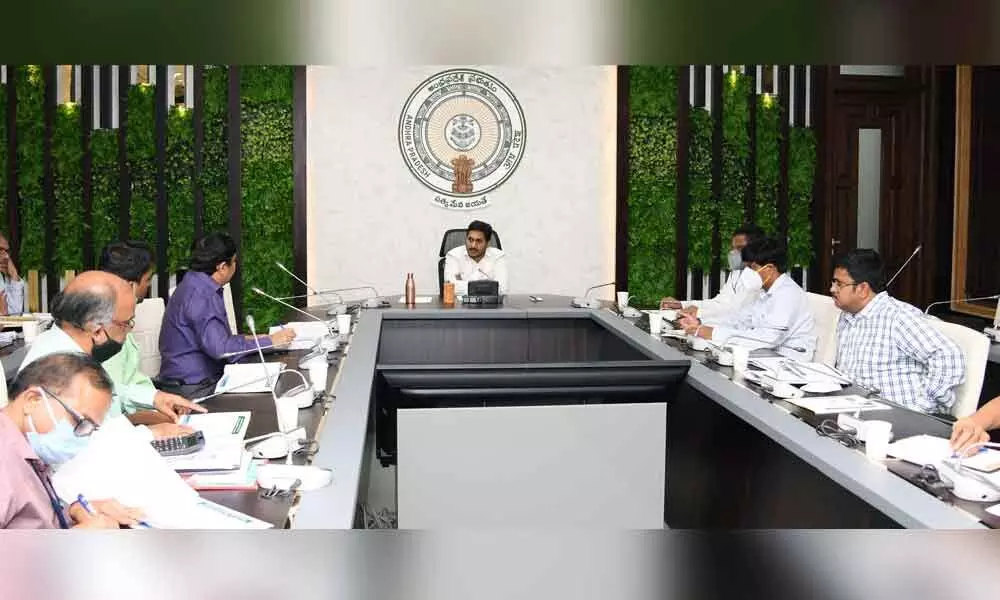 Chief Minister Y S Jagan Mohan Reddy holding a review on housing at his camp office in Tadepalli on Tuesday