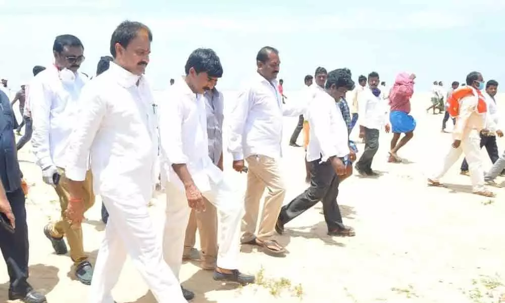 Minister for Marketing, Animal Husbandry Mopidevi Venkataramana along with Minister for Water Resources Dr P Anil Kumar inspecting the site for fish landing centre in Isakapallipalem on Wednesday
