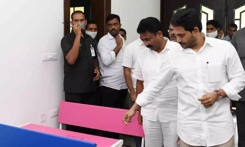 Chief Minister Y S Jagan Mohan Reddy checking the facilities to be provided in schools  as part of Naadu-Nedu at his camp office in Tadepalli on Wednesday