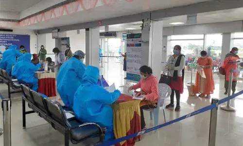 Migrant workers belonging to the state arrive at  Vijayawada airport from Kuwait on Thursday