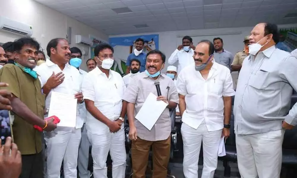 Ministers Balineni Srinivas Reddy, Audimulapu Suresh, Collector Pola Bhaskara and others sharing lighter moment with a driver in the Vahana Mitra programme in Ongole on Thursday