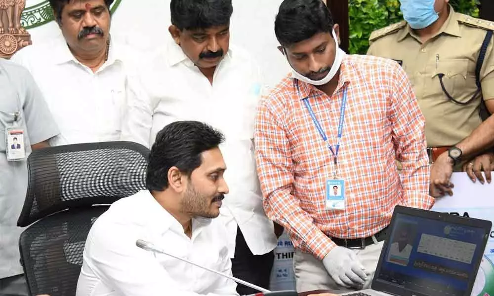 Chief Minister Y S Jagan Mohan Reddy releasing amount to auto, taxi drivers-cum-owners under Vahana Mitra scheme at his camp office in Tadepalli on Thursday