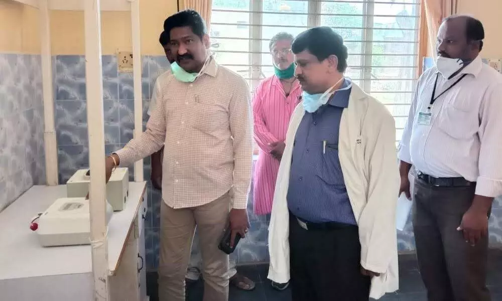 Chittoor District TB control officer Dr B Ramesh Babu examining the TrueNat machine at  Madanapalle (file photo)