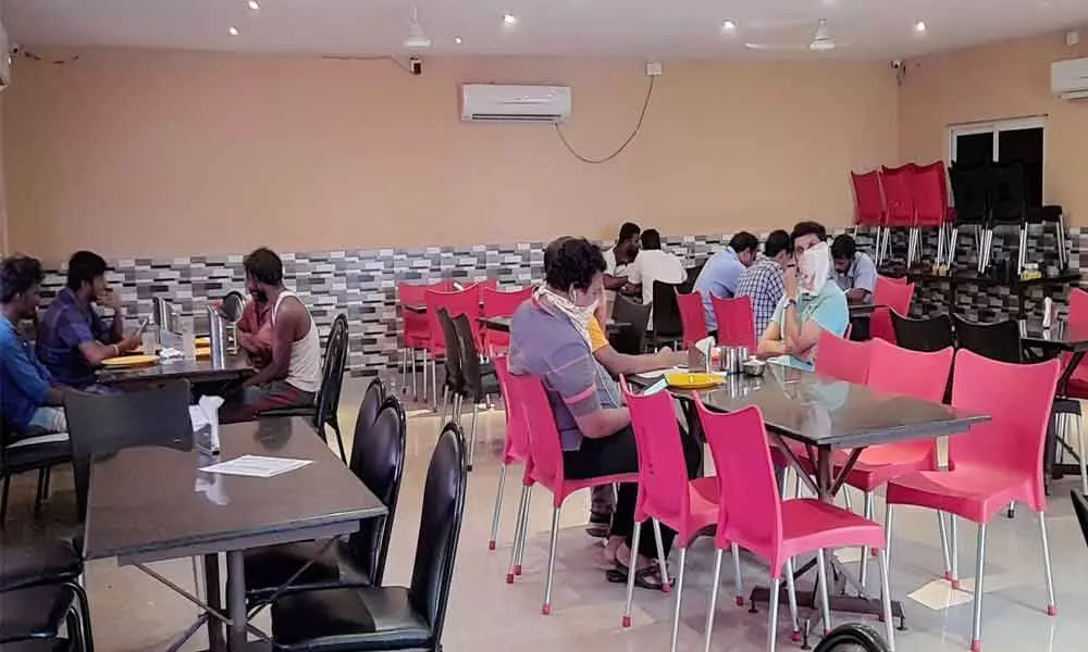 Safety protocol takes a backseat as four diners share a table at a restaurant in Visakhapatnam.