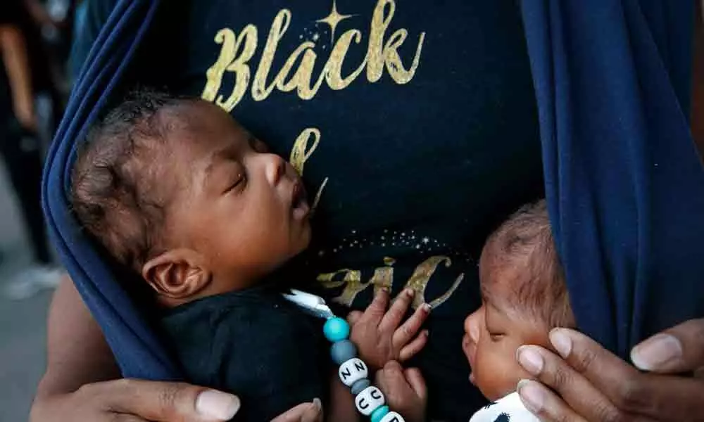 Eight-week-old twins Zuri and Zakai Simmorins are held by their mother Samara Simmorins during a protest on Sunday, near the White House in Washington, over the death of George Floyd, a black man who was in police custody in Minneapolis