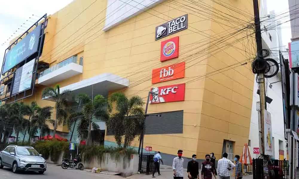 Customers visiting a shopping mall on MG Road in Vijayawada on Monday