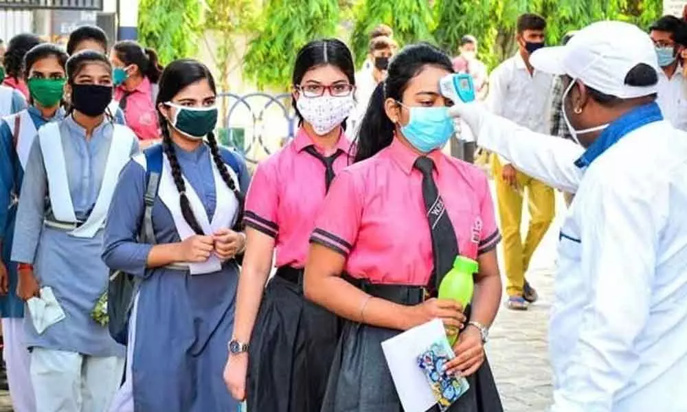 Students wearing protective masks undergo thermal screening before appearing in the 12th class examinations of Madhya Pradesh Board of Secondary Education, during the fifth phase of ongoing COVID-19 lockdown, in Jabalpur on Tuesday.