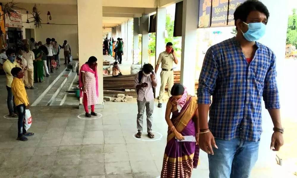 Devotees following social distancing norm in the queue line at Simhachalam temple on Wednesday