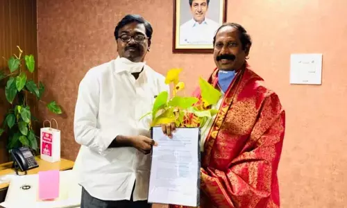 Transport Minister Puvvada Ajay Kumar congratulating SUDA Chairman Bachu Vijay Kumar in Khammam on Thursday