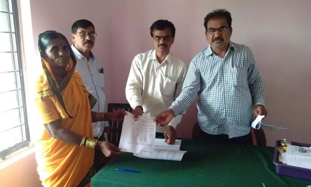 Officials issuing show-cause notice to Chinna Takkadapalli village sarpanch Devubai on Thursday