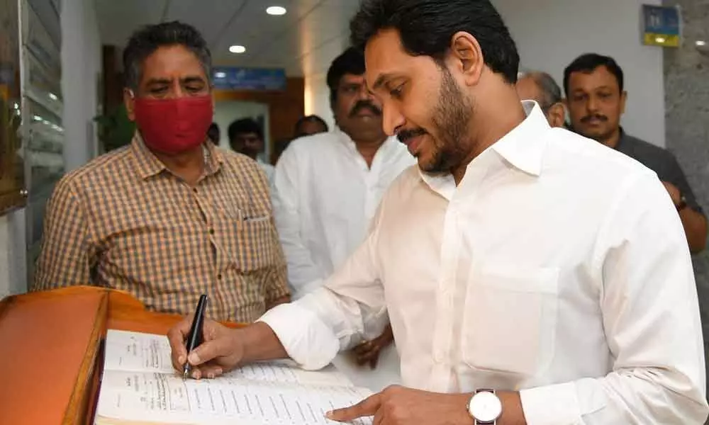 Chief Minister Y S Jagan Mohan Reddy signing the roster before Cabinet meeting at the Secretariat on Thursday