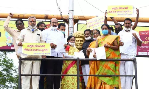 TDP  Ex-MLA Sugunamma and other leaders staging dharna near Jyothirao Phule in Tirupati on Friday condemning the arrest of former minister Atchennaidu by ACB