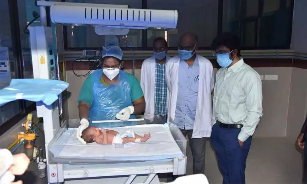 Joint Collector Saikanth Varma (Development) and doctors watching new born baby at  RIMS in Kadapa on Friday
