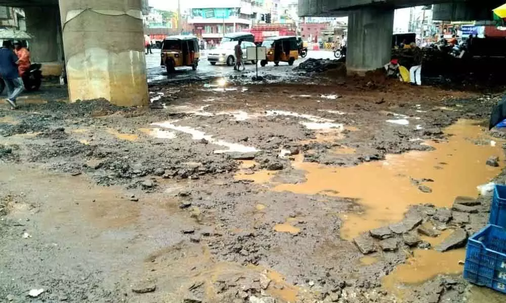 Commuters find it hard to pass via NAD flyover as the road turned worse due to rain, in Visakhapatnam on Friday.  	Photo: Vasu Potnuru