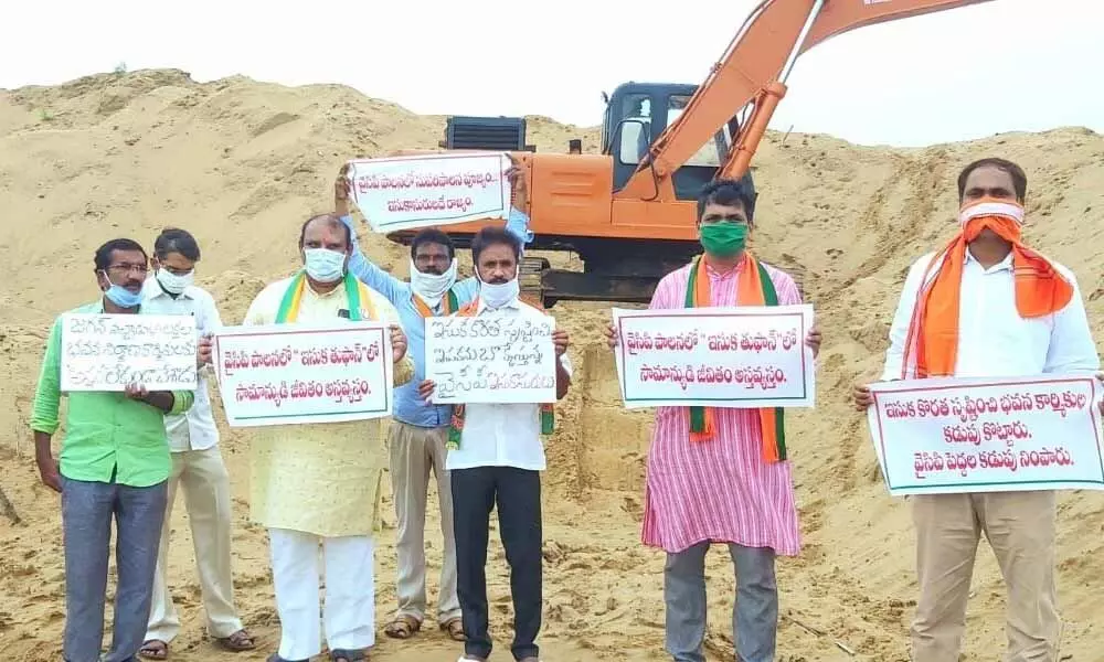 BJP leaders staging protest against government sand policy in Kakinada on Friday