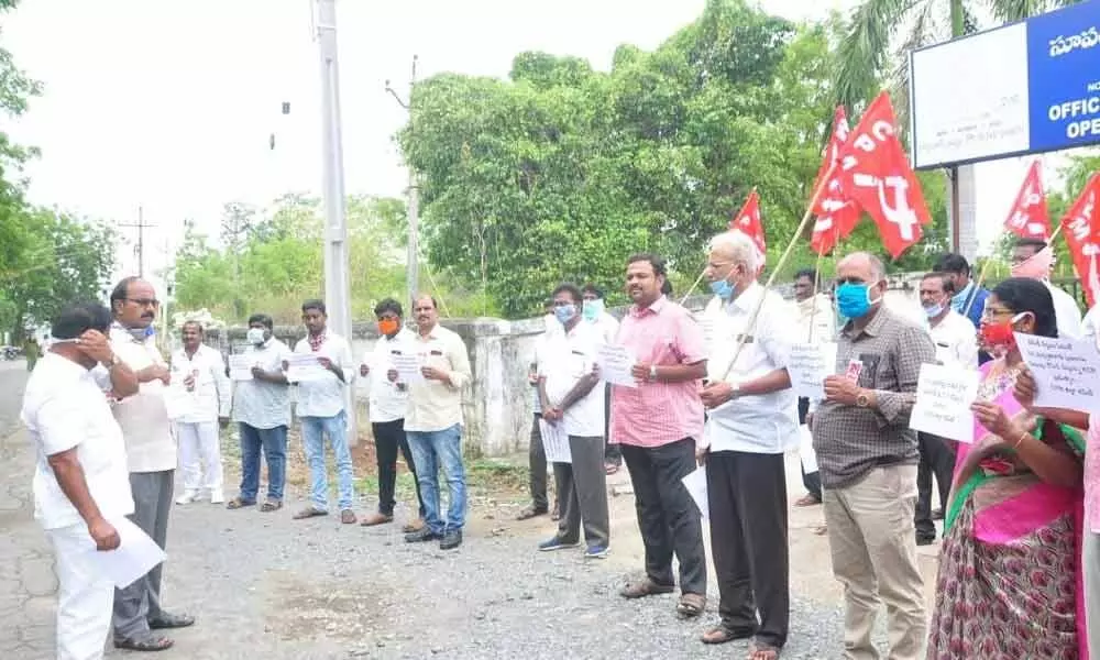 CPM leaders and activists staging a protest at SE office in Khammam on Friday
