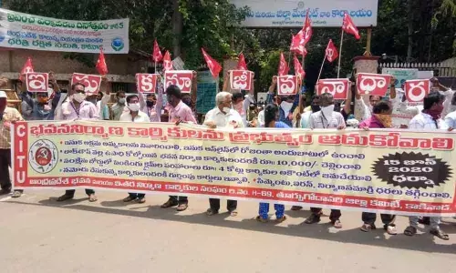 Construction workers stage dharna