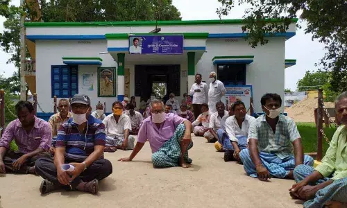 Desaipet villagers who received noticies for the tax they have already paid, staging a protest in front of the panchayat office on Monday