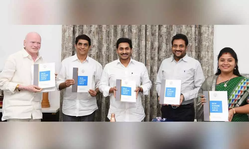 Chief Minister Y S Jagan Mohan Reddy, along with ministers, releasing the Socio-Economic Survey at his camp office on Monday
