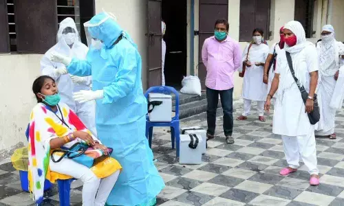 Doctors conducting Covid-19  tests in 13th division in Rajamahendravaram on Tuesday