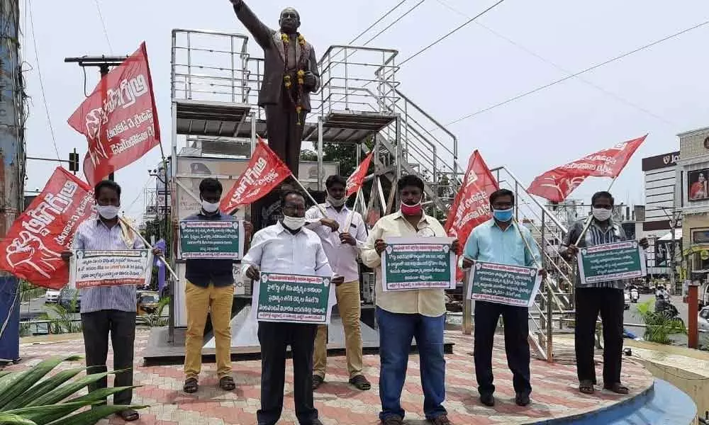 CPI activists protesting at Ambedkar Statue in Guntur on Tuesday