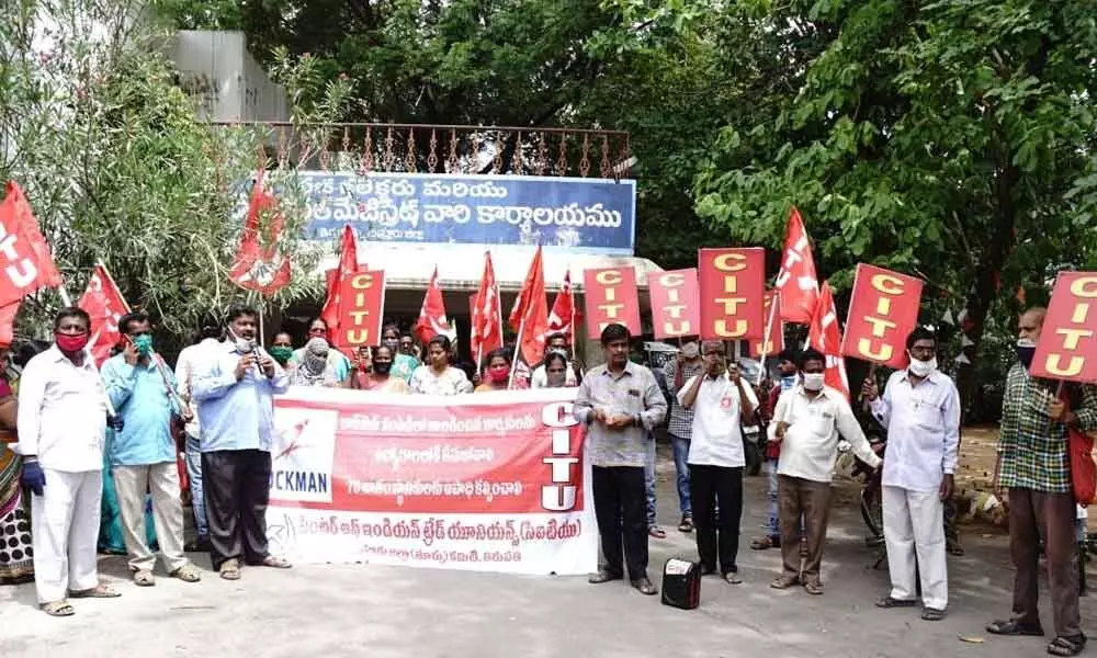 CPI leaders and activists staging a dharna in front of Electricity SE office in Karimnagar on Tuesday