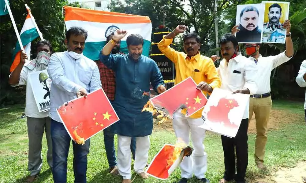 Protesting the killing of Indian jawans by People's Liberation Army in Galwan Valley, BJP leaders burn Chinese flags near Amar Jawan memorial at Kapilatheertham junction