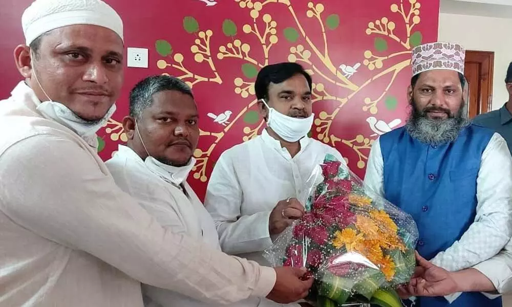 Muslim leaders present a boquet to Minister Amzath Basha in Vijayawada on Thursday