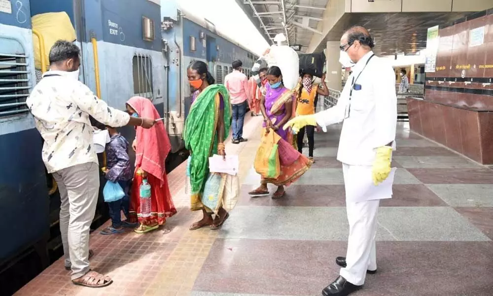 Migrant labourers from Odisha boarding Shramik Special train to their State, in Tirupati  on Thursday