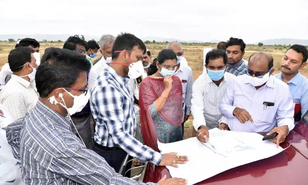 District Collector Ch Harikiran inspecting land needed for Jagananna Colonies at Chennuru in Kadapa district on Thursday
