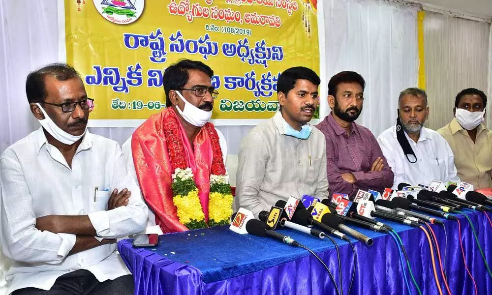 Chairman of the AP Govt Employees Federation K Venkatrami Reddy and others addressing media in Vijayawada on Friday