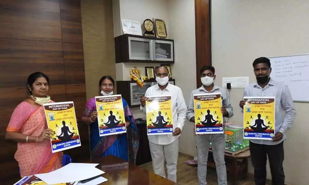 GMC Commissioner Challa Anuradha and officials releasing posters relating to World Yoga Day in Guntur on Friday