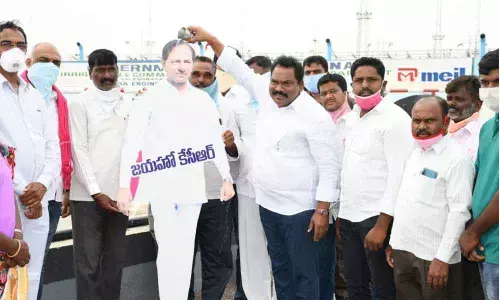 MLA S Ravi Shankar giving milk bath to Chief Minister K Chandrashekar Rao’s flexi at Ramadugu mandal on Sunday