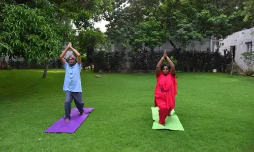 Telangana Governor Tamilisai Soundararajan along with her husband  performing yoga asana at Raj Bhavan