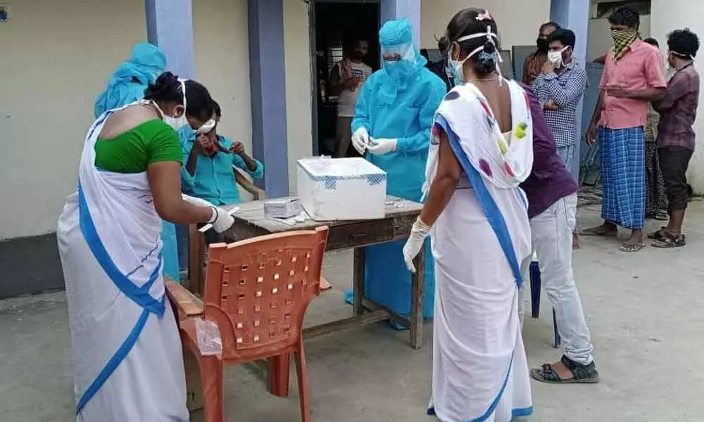 Hans News Service   Asha workers (white sarees) attending duties at quarantine centres in Srikakulam.