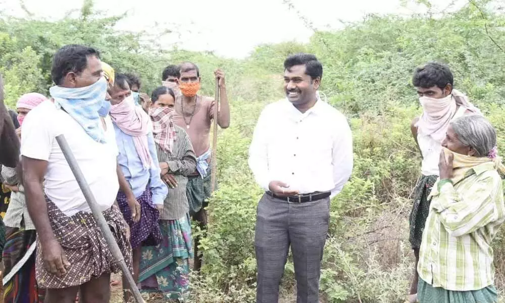 District Collector Gandham Chandrudu interacting with NREGS workers  at Battalapalle village in  Anantapur district