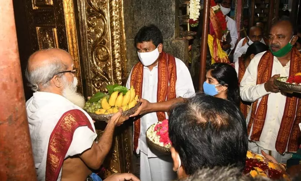Minister for Endowments Vellampalli Shrinivas Rao and family members presenting silk robes to Goddess Kanakadurga