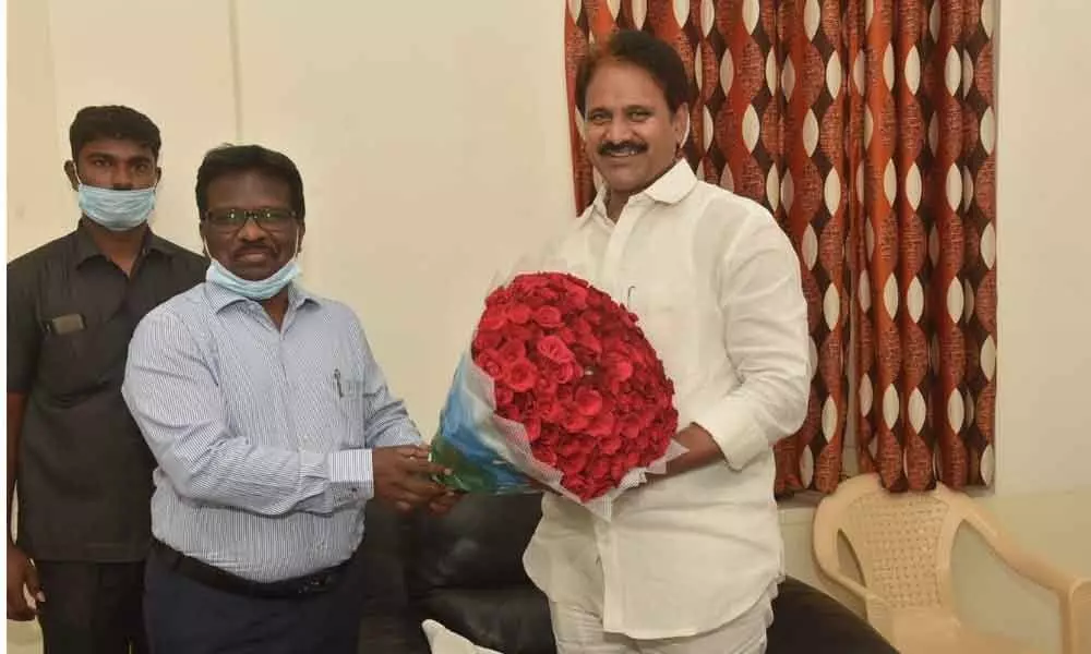 District Collector I Samuel Anand Kumar giving a flower bouquet to Minister for Fisheries Mopidevi Venkata Ramana Rao in Guntur on Monday