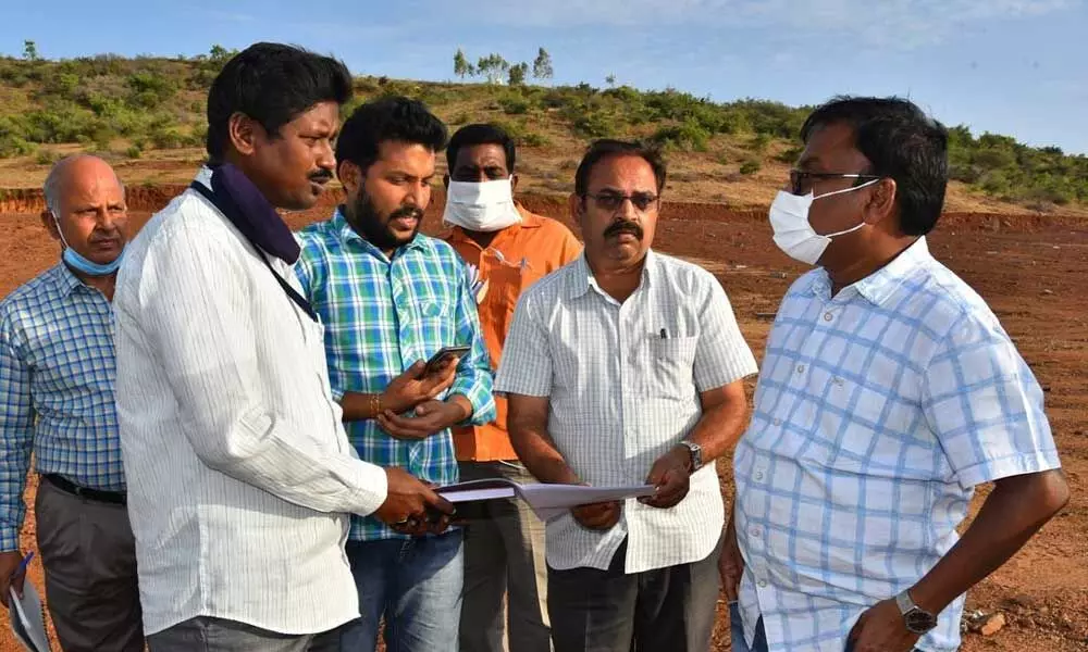 Prakasam District Collector Dr Pola Bhaskara and Ongole tahasildar Chiranjeevi inspecting the land for housing sites