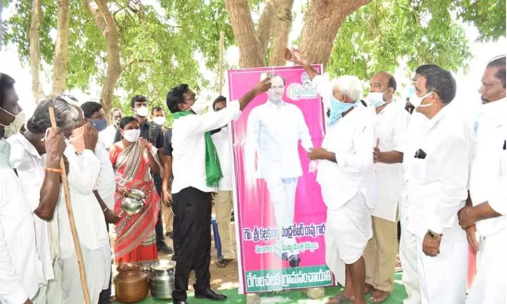 Minister for Transport Puvvada Ajay Kumar performing milk  bath to the portrait of Chief Minister K Chandrashekar Rao  at Koyachilaka village on Wednesday
