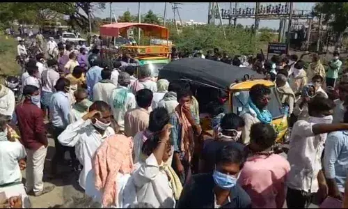 Tobacco farmers staging protest at the auction center in Kondapi on Thursday