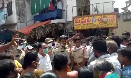 Police and Municipal staff interacting with farmers and traders at Elamanchili on Thursday
