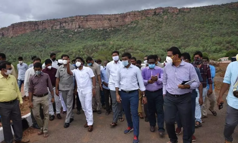 Education Minister A Suresh and others inspecting development works at Idupulapaya in Kadapa district on Friday