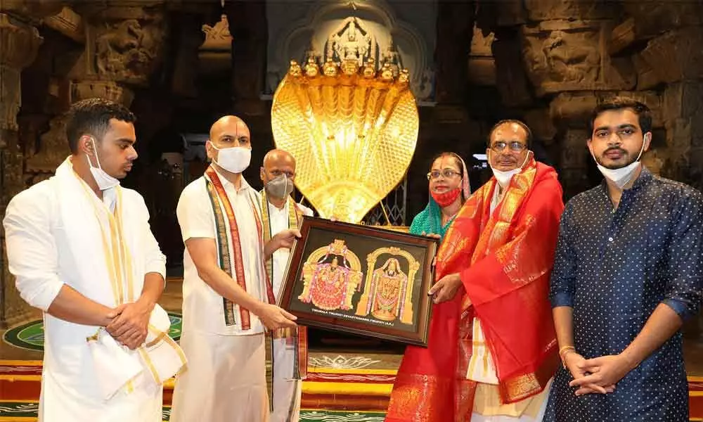 TTD Executive Officer Anil Kumar Singhal presenting a portrait of Lord Venkateswara and Goddess Padmavathi to Madhya Pradesh CM Shivraj Singh Chouhan in Tirumala on Saturday