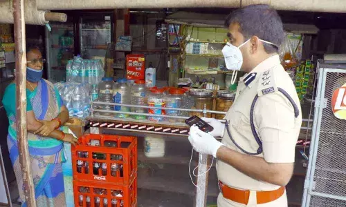 Urban SP A Ramesh Reddy giving counselling to a petty shop owner against sale of tobacco products