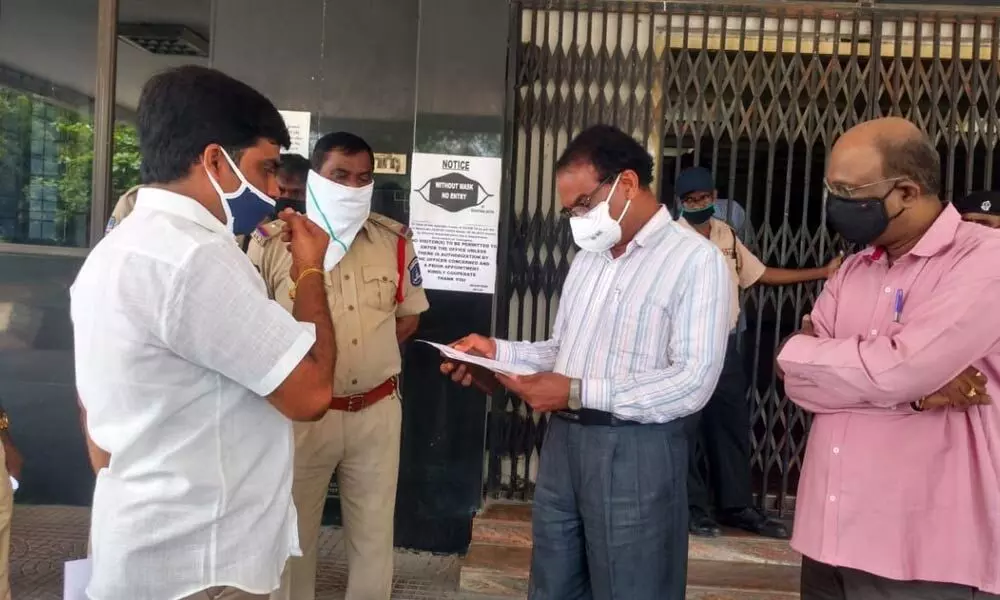 JNTU-H, Director Academic and Audit Cell Dr K Rammohan Reddy receivig representation from the faculty protesting for pending salaries