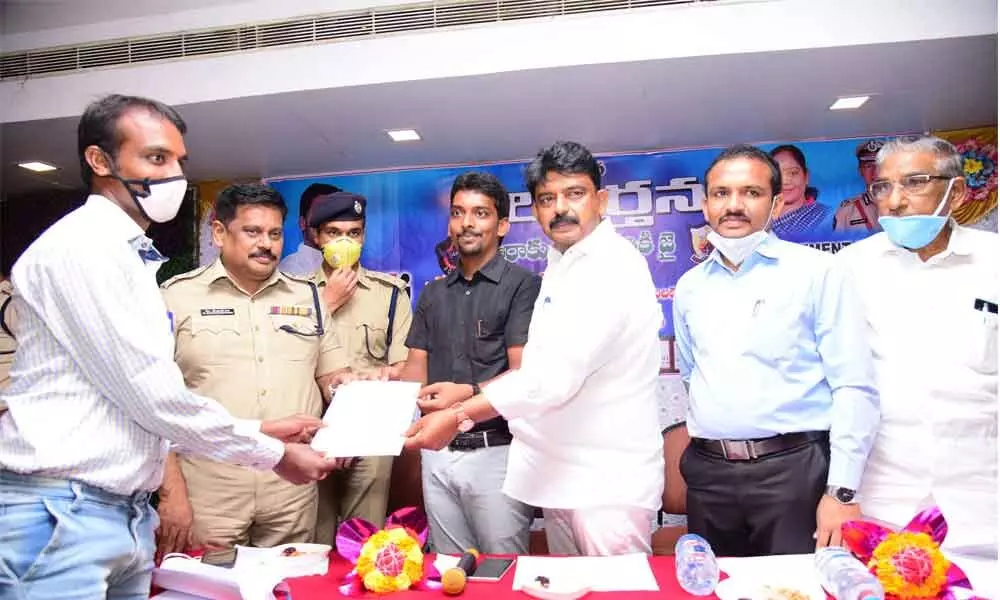 Transport Minister Perni Nani offering job letter to a youth at Job mela in Machilipatnam on Wednesday
