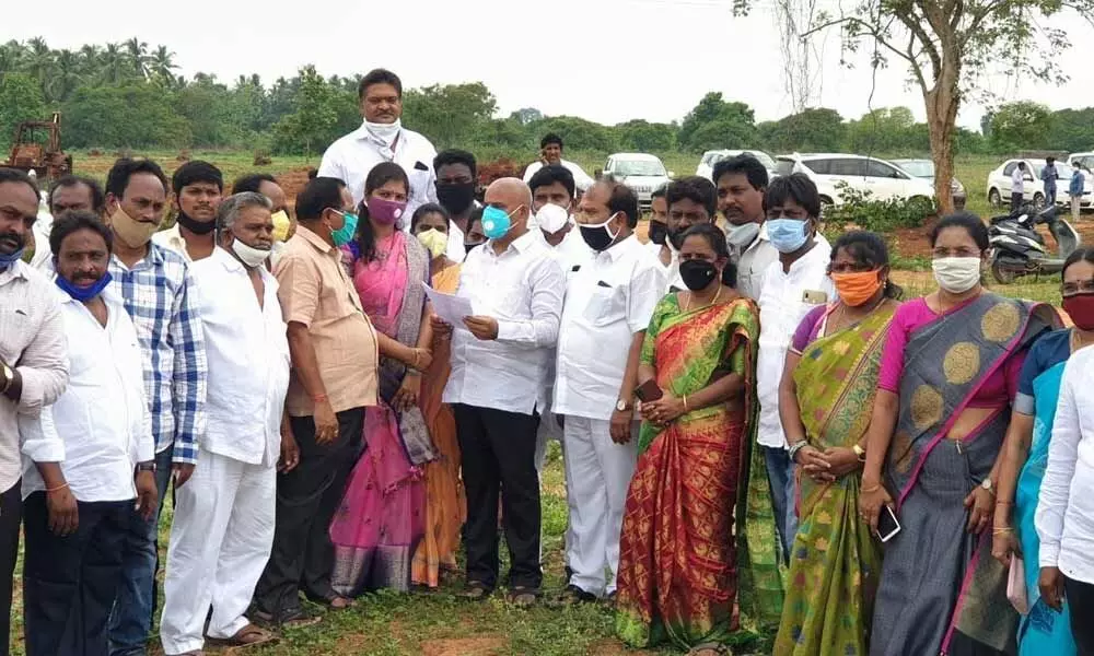 YSRCP city coordinator S Sivarama Subramanyam along with party leaders enquiring about the proposed house sites