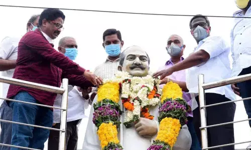 Pantham Satyanarayana Charitable Trust chairman and local channel managing director Pantham Kondala Rao and MS Murthi garlanding the statue of cine artiste SV Ranga Rao at Godavari bund in Rajamahendravaram on Friday in connection with his birth anniversary celebrations