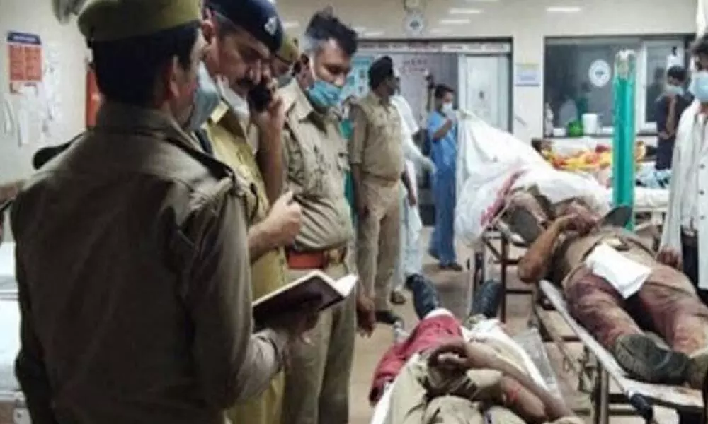 Police officers from the Uttar Pradesh police department speak to the injured policemen. Police officers in Kanpur were attacked by Vikas Dubey’s gang when they were raided on Friday.